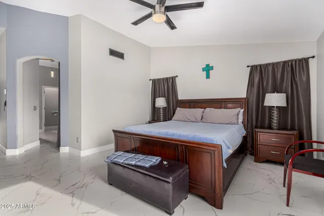 a bedroom with a bed and a chandelier