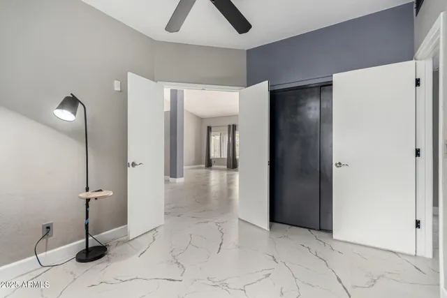 a view of a livingroom with a ceiling fan and window