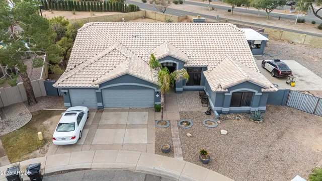 an aerial view of a house with a yard and lake view