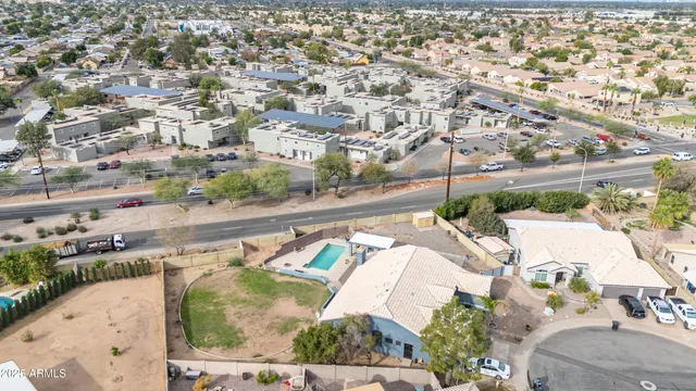 an aerial view of a house with a garden and trees