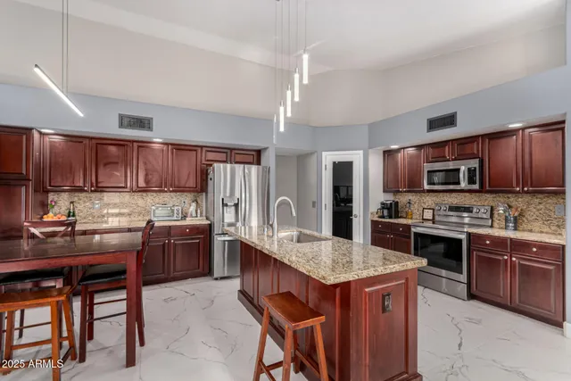 a kitchen with a sink refrigerator and cabinets