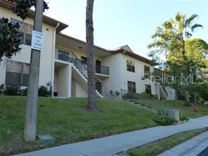 a front view of house with a garden