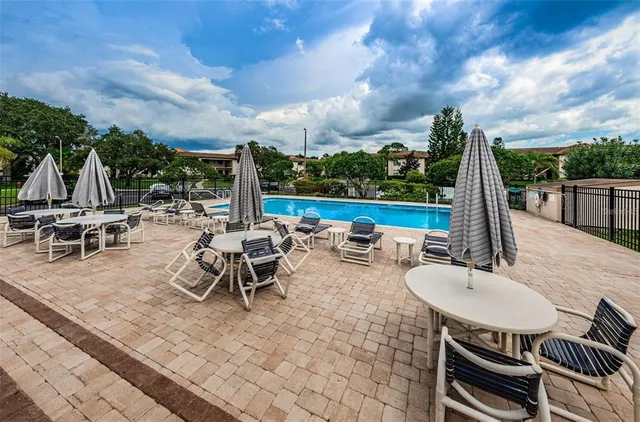 a view of a patio with a table chairs and a backyard