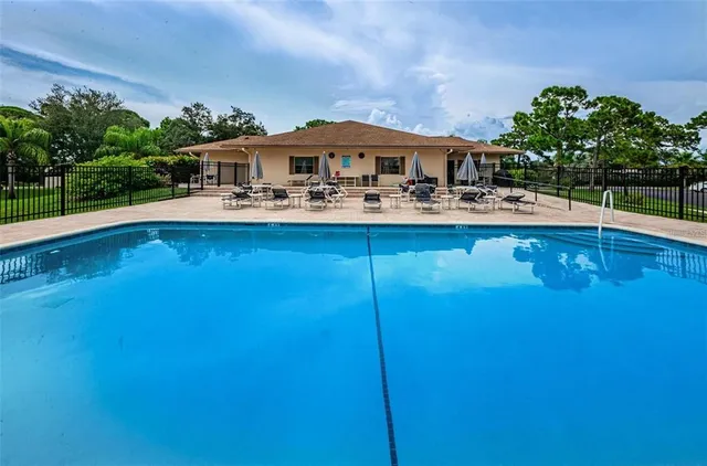 a front view of house with a garden and swimming pool