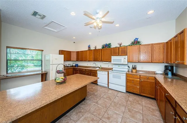 a kitchen with a stove a sink and a refrigerator