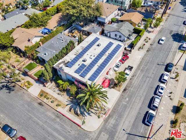 an aerial view of a residential houses with open space