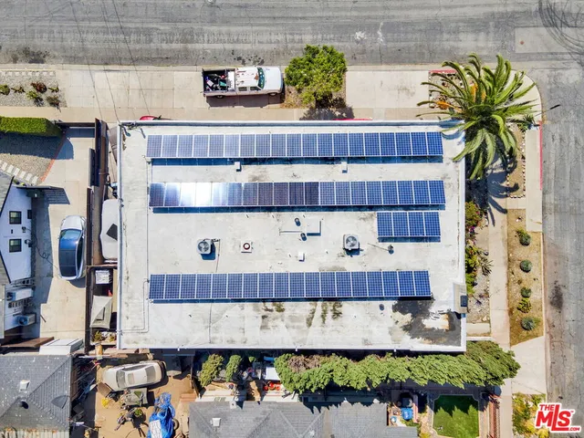 an aerial view of residential houses with outdoor space and street view