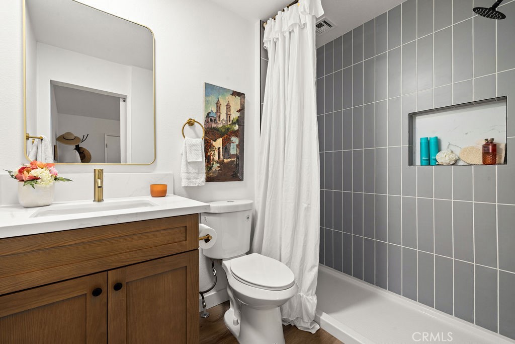 249 Alru Street Rialto, CA 92376 - Photo 12 of 33 Remodeled bathroom with tiled shower, updated vanity, and fixtures