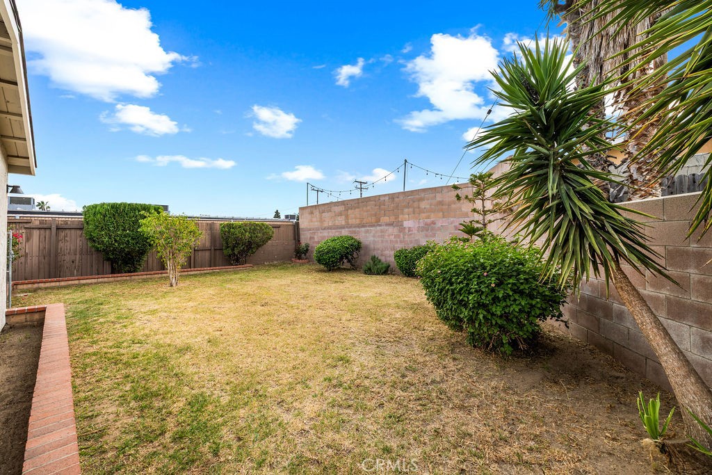 249 Alru Street Rialto, CA 92376 - Photo 23 of 33 Backyard with mature landscaping and fencing