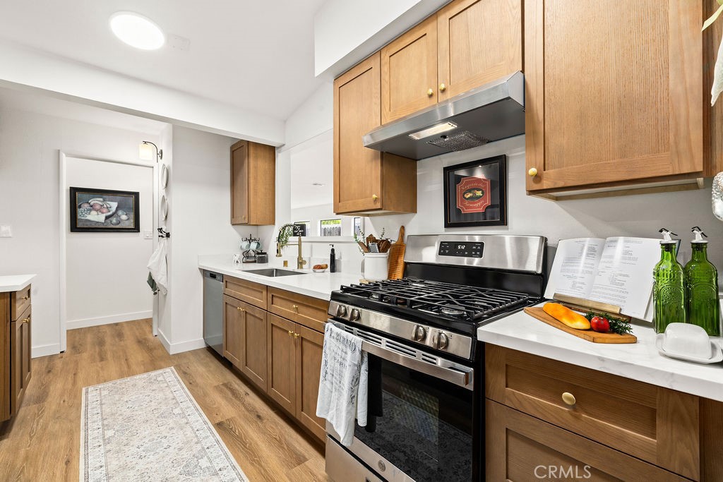 249 Alru Street Rialto, CA 92376 - Photo 3 of 33 Updated kitchen with quartz-style counters, gas range, and wood cabinetry