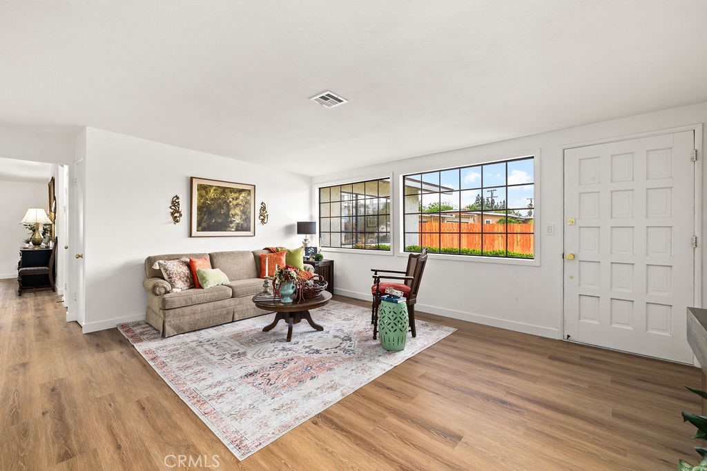 249 Alru Street Rialto, CA 92376 - Photo 8 of 33 Bright living space with wide-plank flooring and multiple seating areas