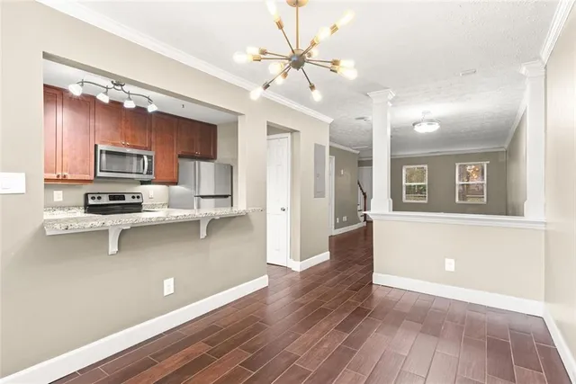 a view of kitchen with sink microwave and stove