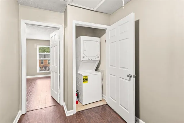 a view of an entryway with wooden floor and door