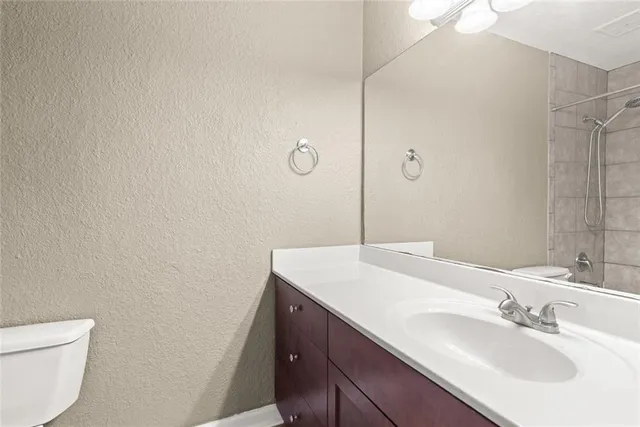 a bathroom with a sink a toilet and vanity