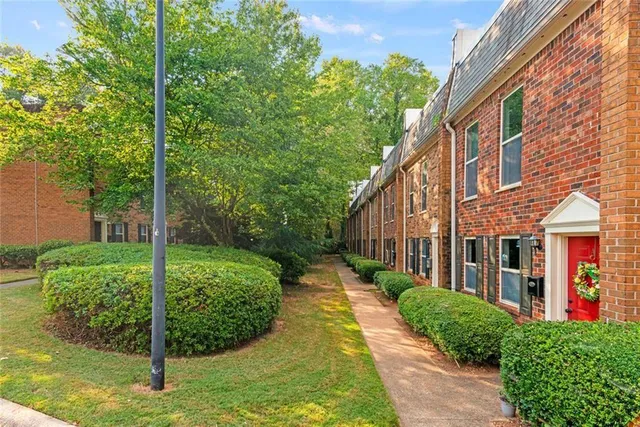 a view of a house with brick walls