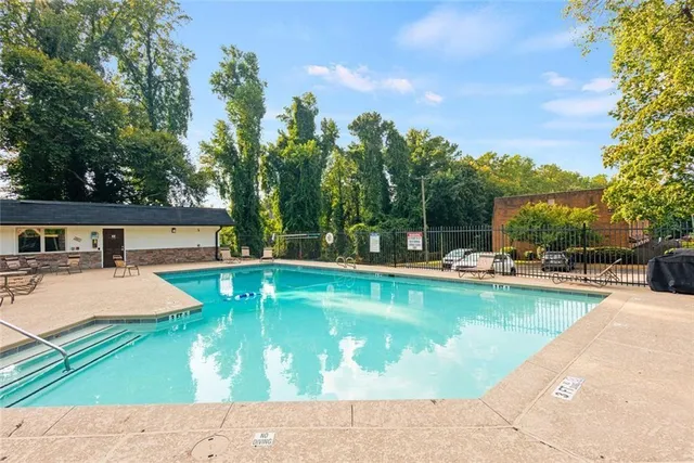 a view of a swimming pool with lounge chair