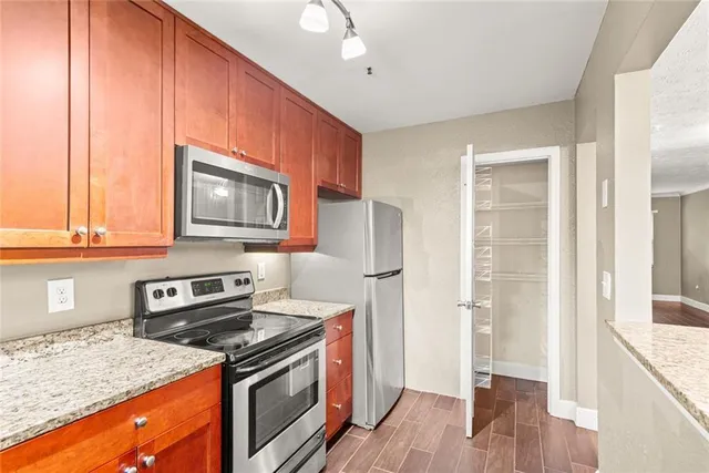 a kitchen with a stove a sink and a microwave