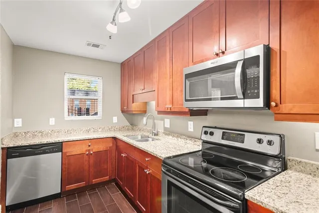 a kitchen with a stove a sink and a microwave