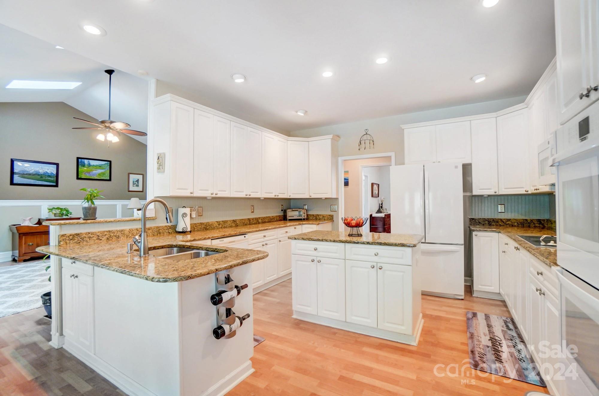 8387 Fairfield Forest Road Denver, NC 28037 - Photo 11 of 38 a kitchen that has a sink a stove counter top space and cabinets
