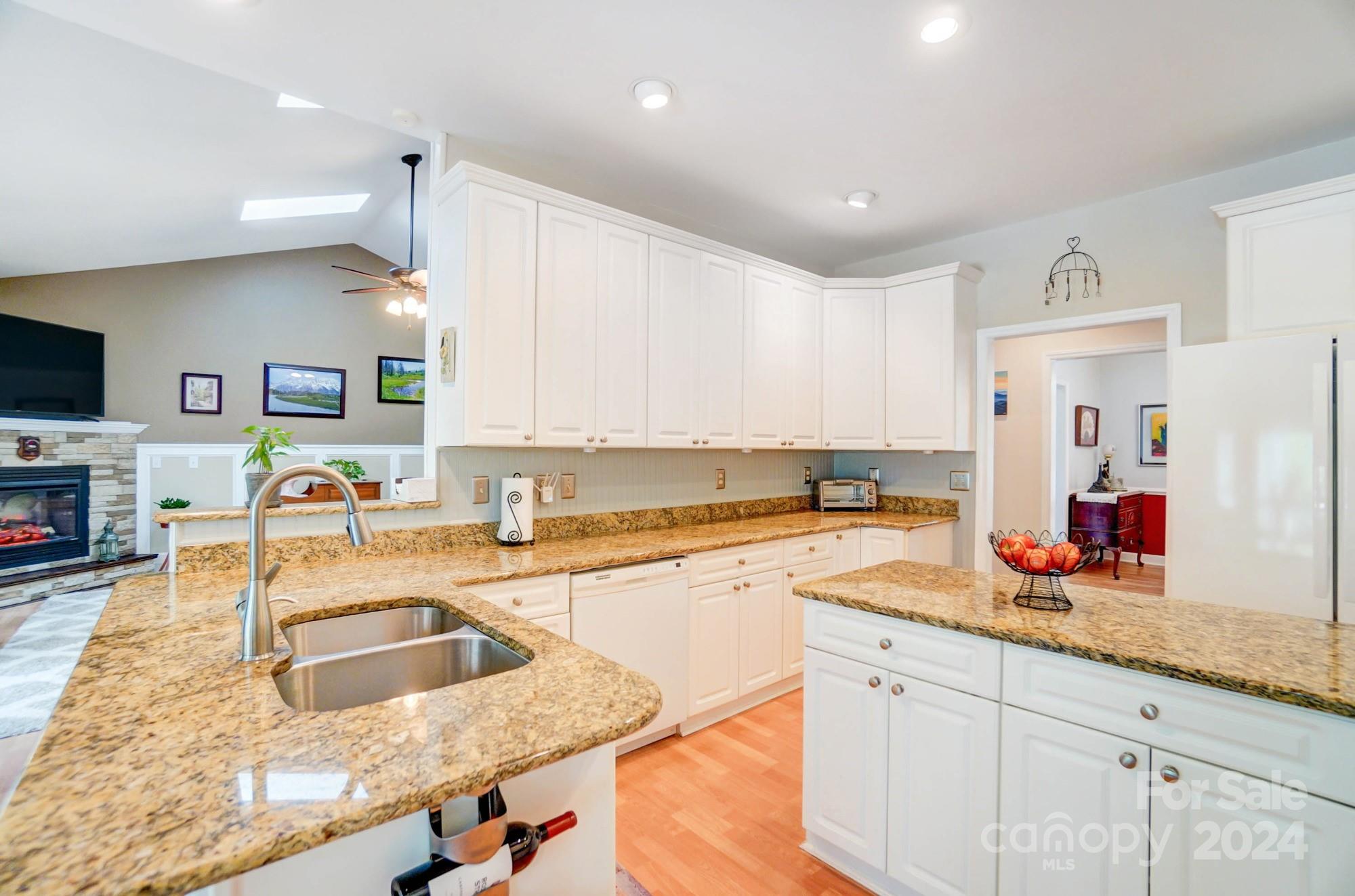 8387 Fairfield Forest Road Denver, NC 28037 - Photo 14 of 38 a kitchen with granite countertop a sink stove and cabinets