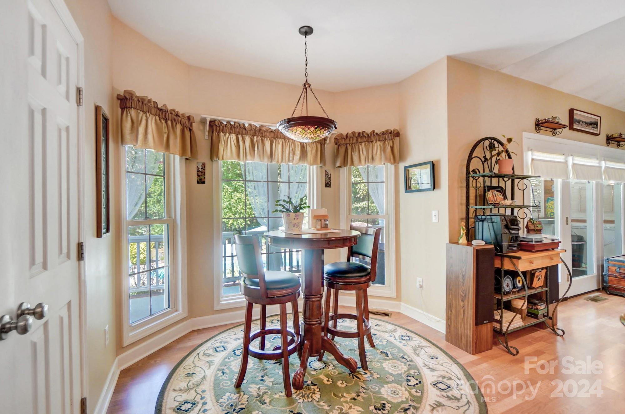 8387 Fairfield Forest Road Denver, NC 28037 - Photo 16 of 38 a dining room with furniture and a window