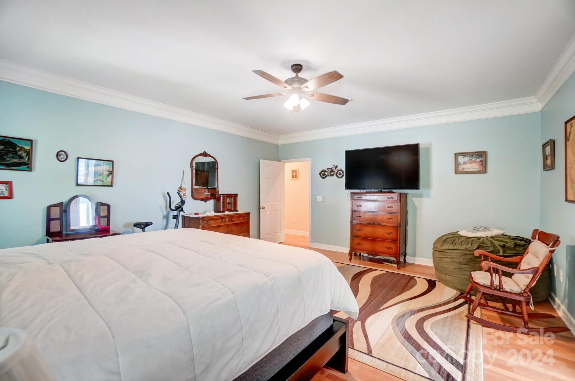 8387 Fairfield Forest Road Denver, NC 28037 - Photo 21 of 38 a bedroom with a bed and a flat screen tv
