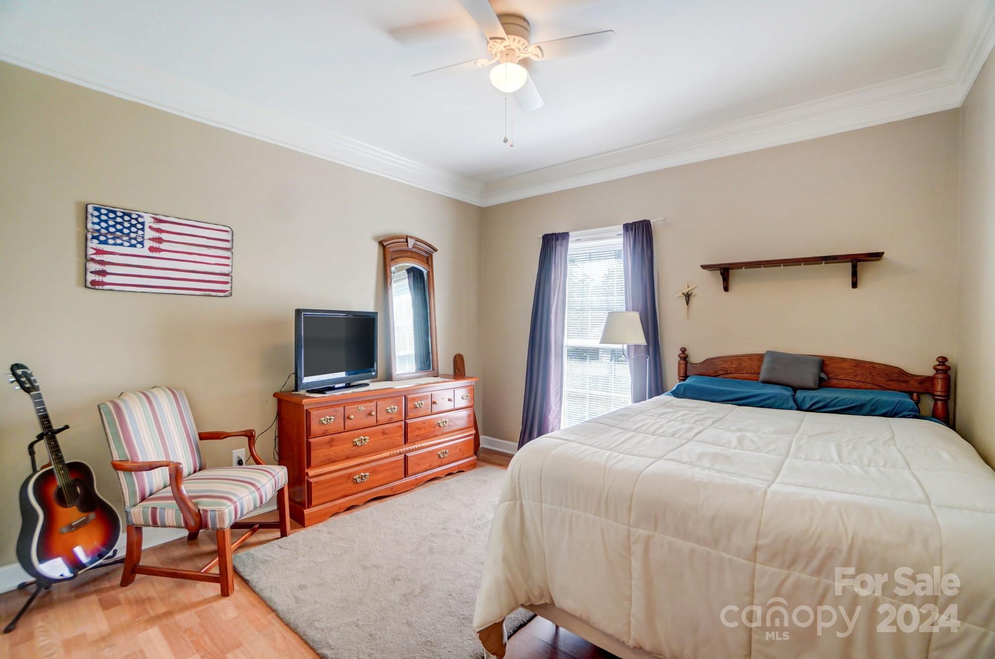 8387 Fairfield Forest Road Denver, NC 28037 - Photo 25 of 38 a bedroom with a bed and a chandelier