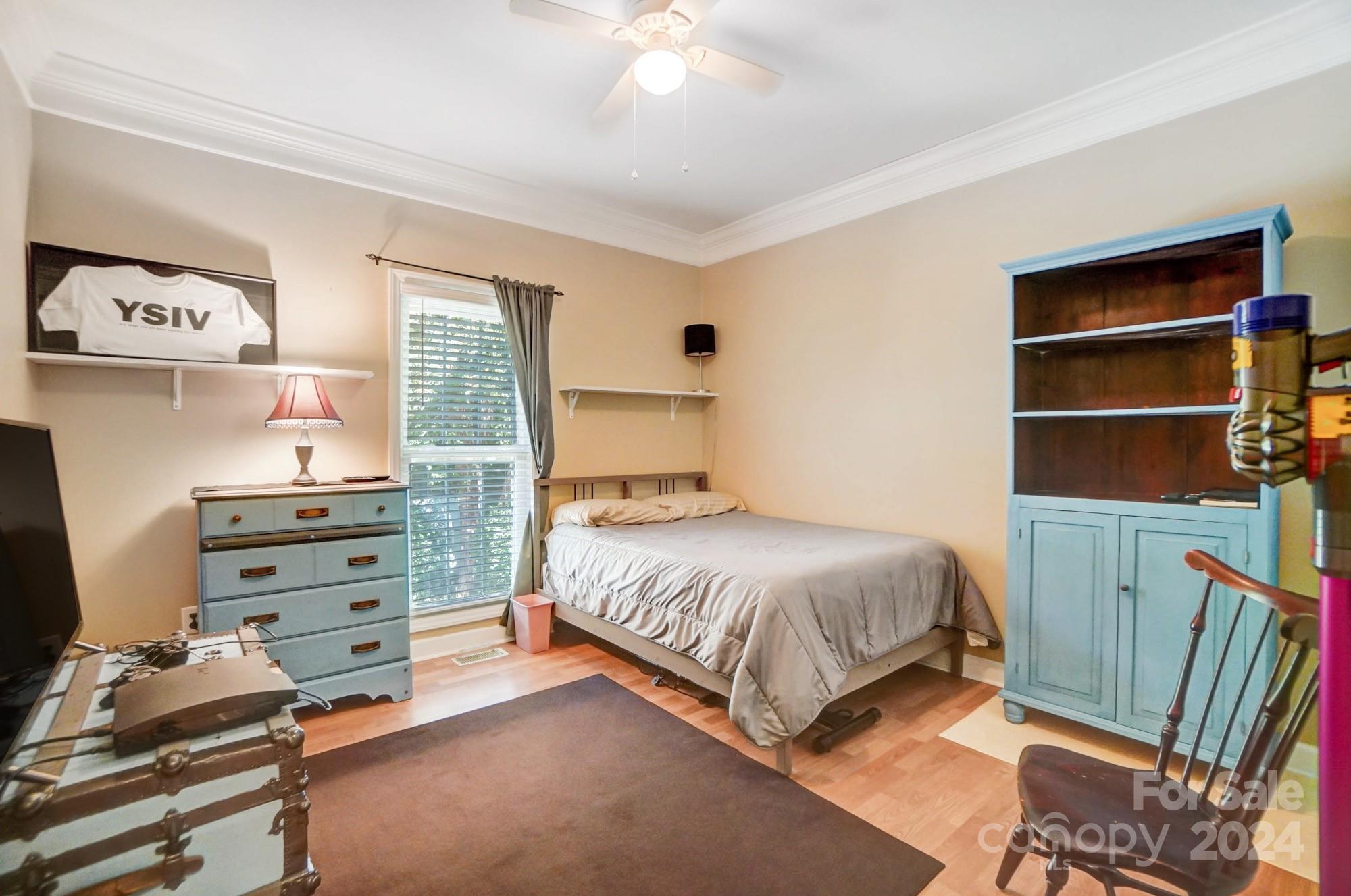 8387 Fairfield Forest Road Denver, NC 28037 - Photo 26 of 38 a bedroom with a bed and a flat tv screen