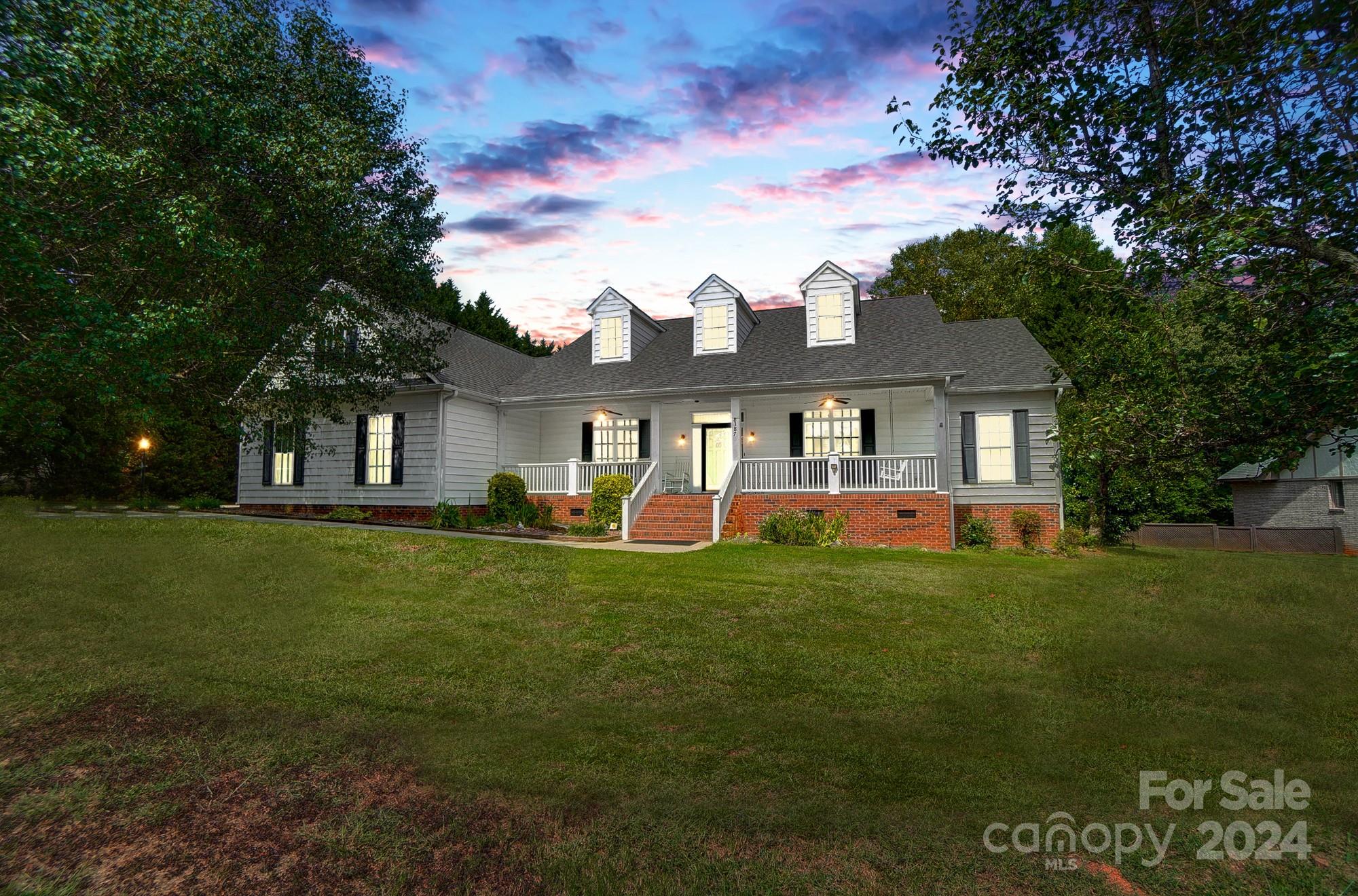 8387 Fairfield Forest Road Denver, NC 28037 - Photo 3 of 38 a front view of a house with a garden