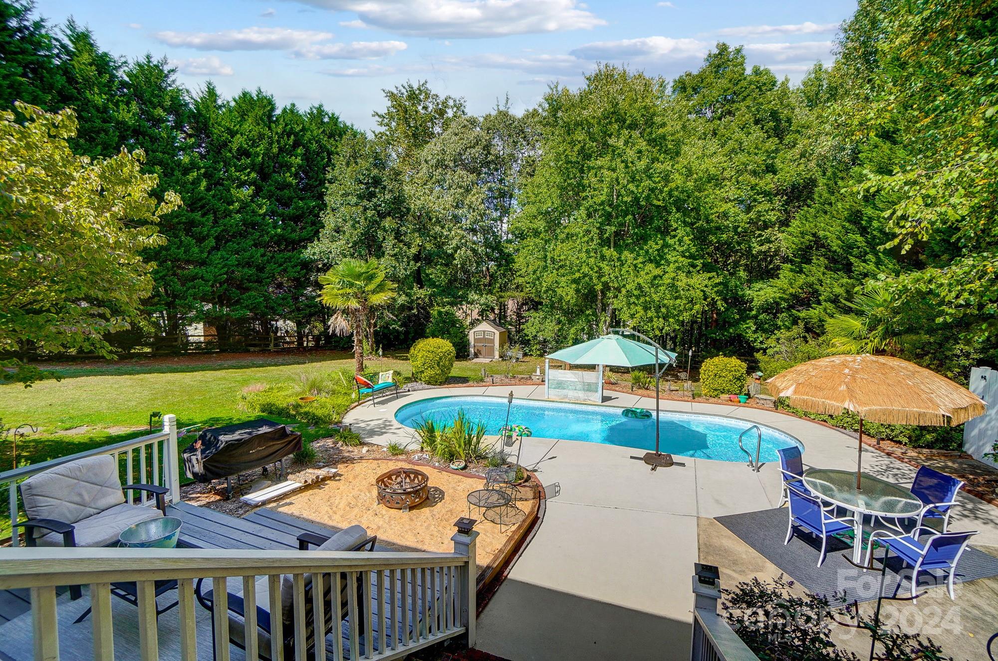 8387 Fairfield Forest Road Denver, NC 28037 - Photo 33 of 38 a view of a swimming pool and outdoor seating