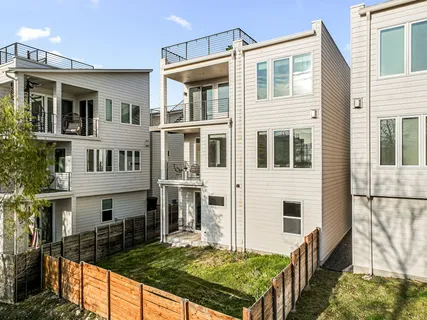 a view of an house with backyard and balcony