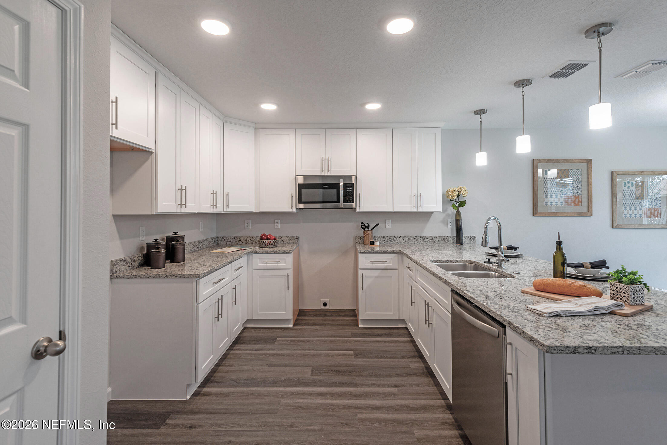 13611 Benton Street Jacksonville, FL 32218 - Photo 12 of 32 a kitchen with granite countertop kitchen island sink stove and cabinets