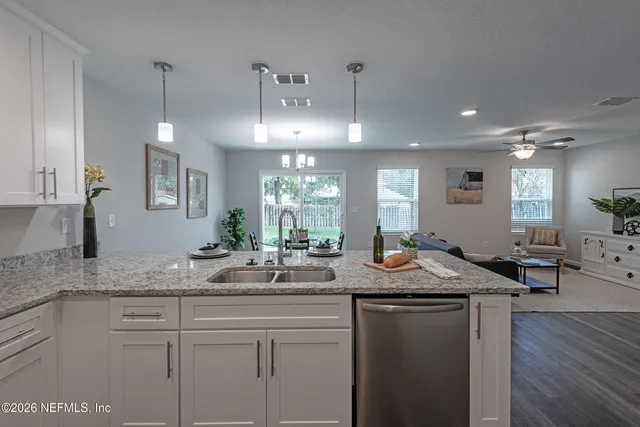 a kitchen with center island table and chairs