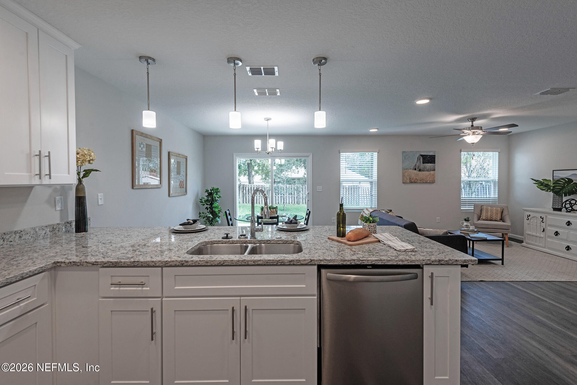 13611 Benton Street Jacksonville, FL 32218 - Photo 16 of 32 a kitchen with center island table and chairs