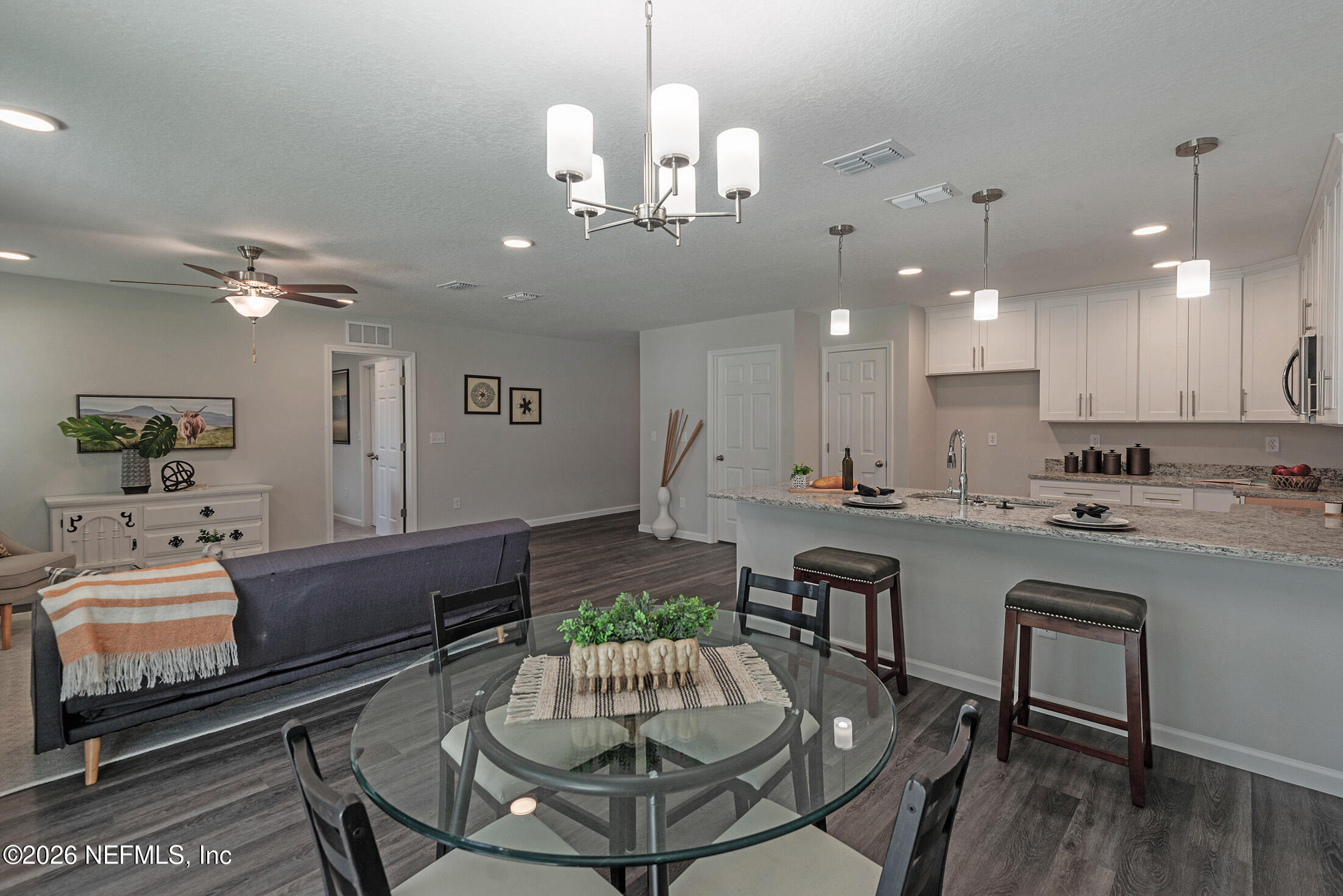 13611 Benton Street Jacksonville, FL 32218 - Photo 19 of 32 a kitchen with a dining table and chairs