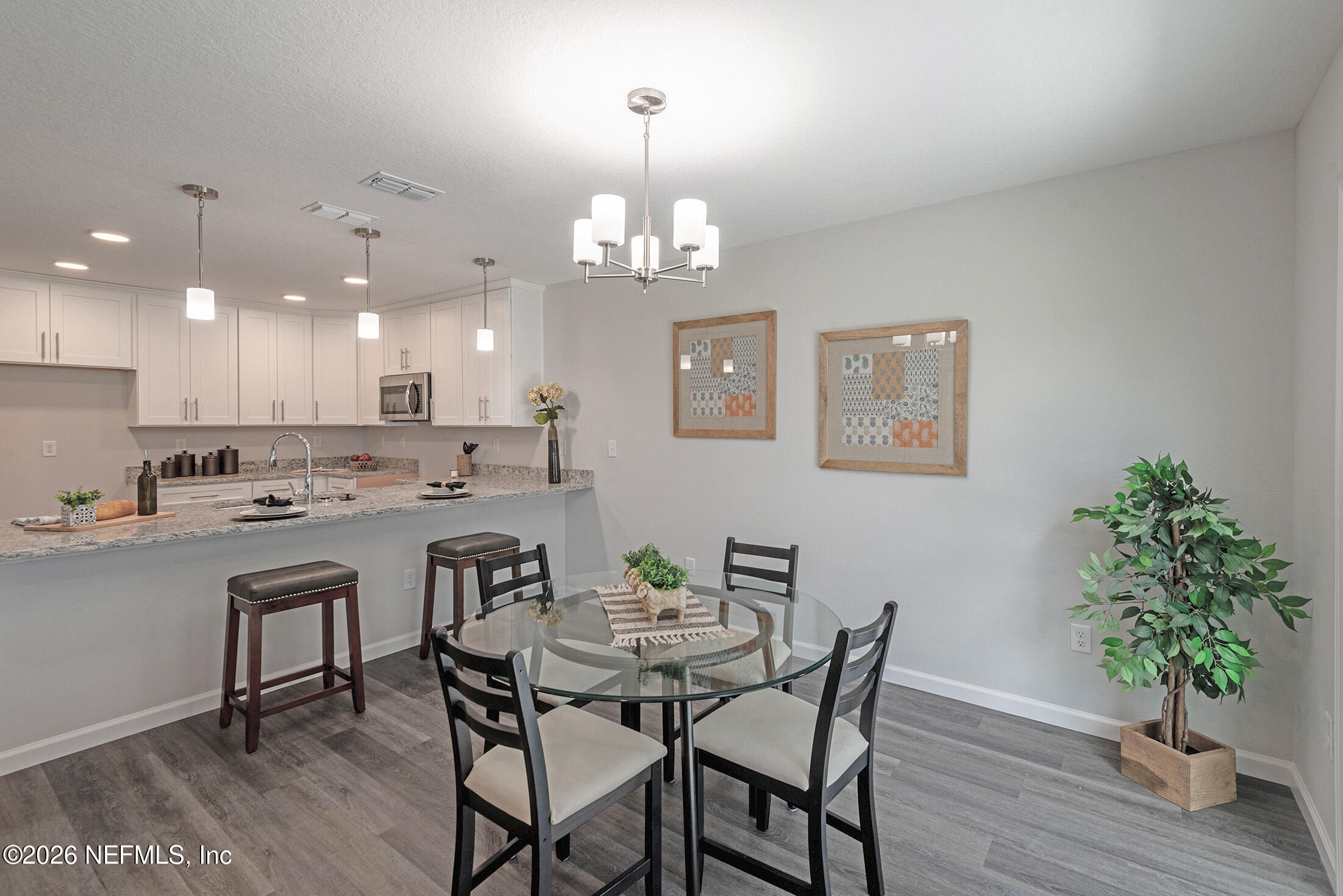 13611 Benton Street Jacksonville, FL 32218 - Photo 20 of 32 a view of a dining room with furniture wooden floor and a chandelier
