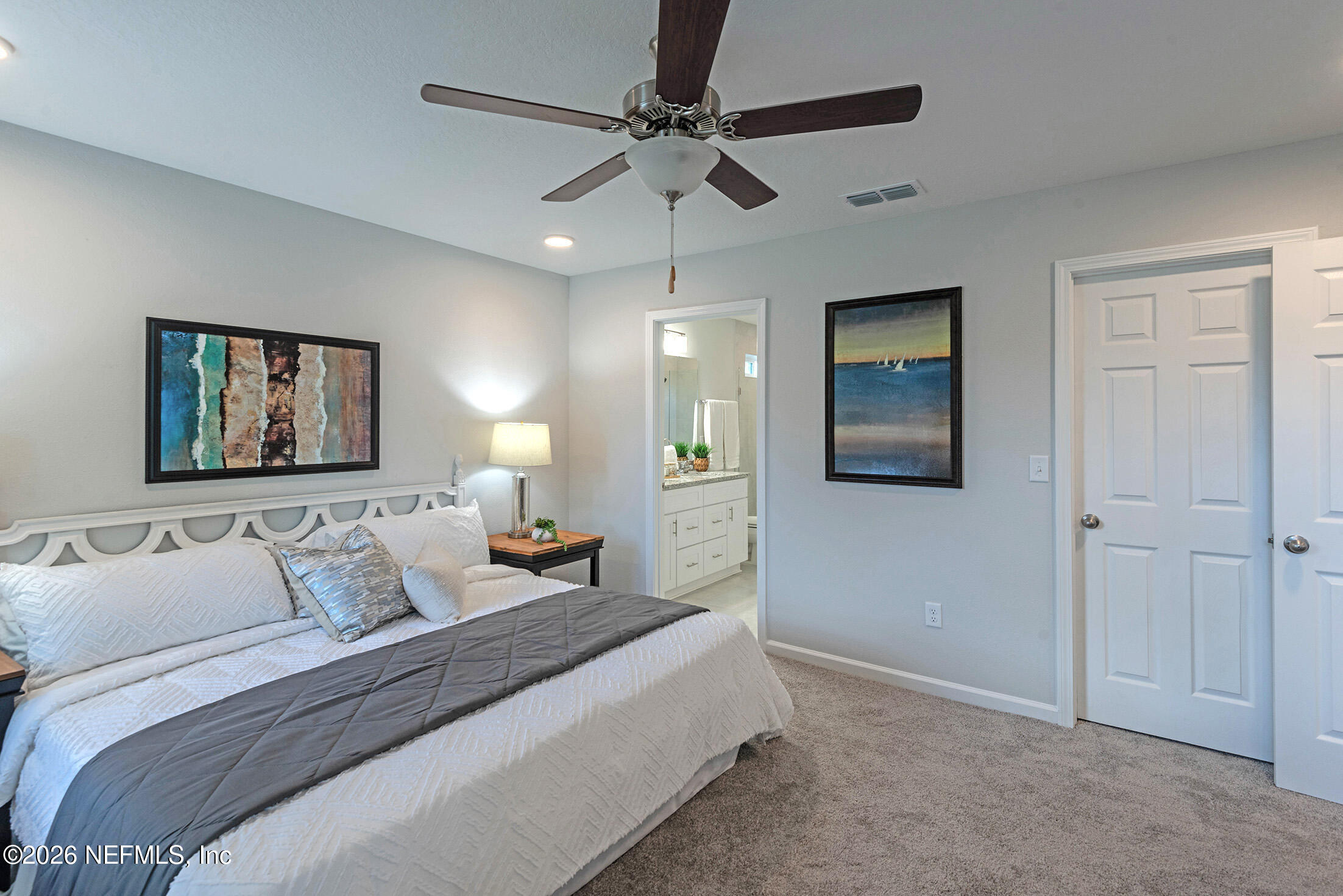 13611 Benton Street Jacksonville, FL 32218 - Photo 24 of 32 a bedroom with a bed and lamp