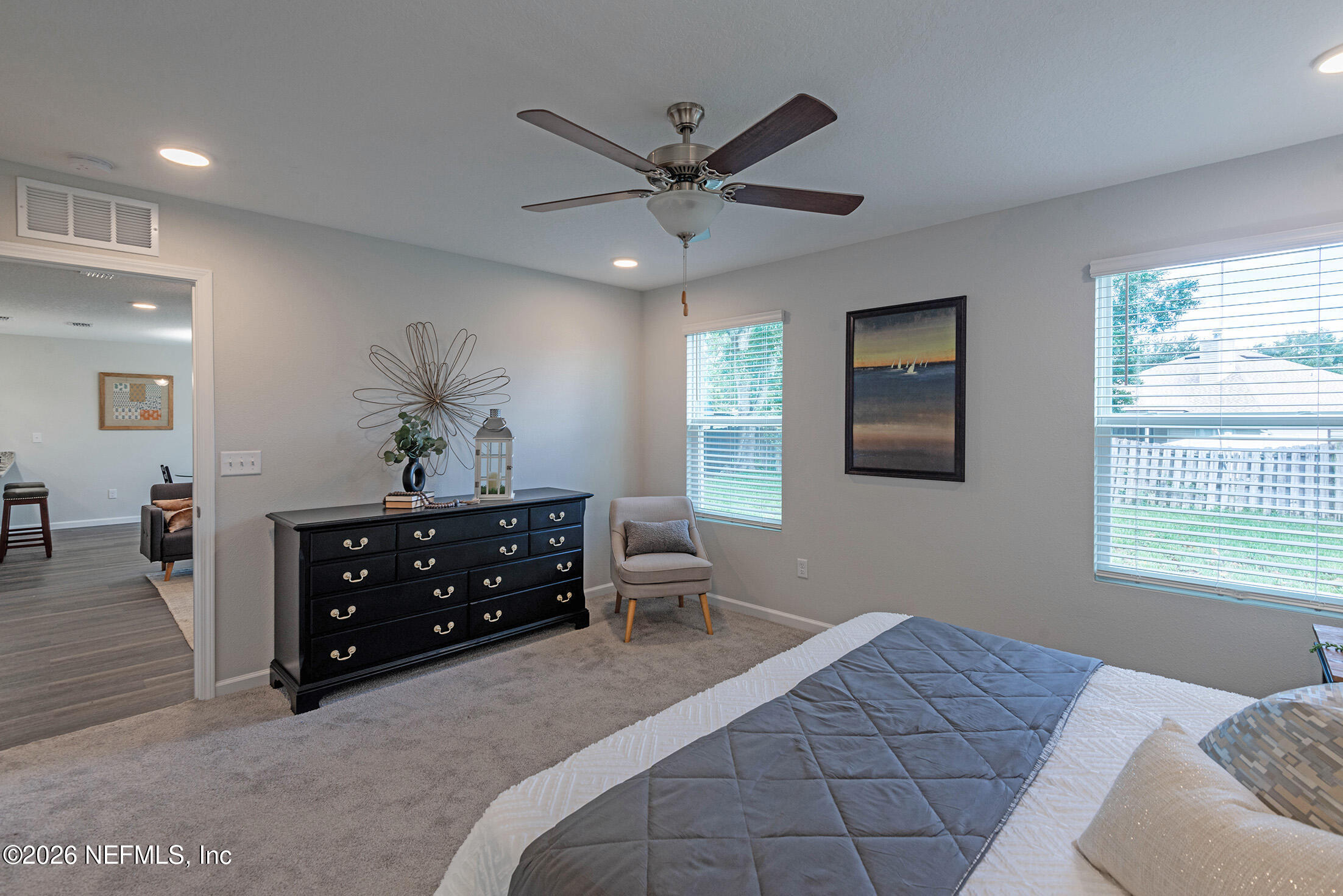 13611 Benton Street Jacksonville, FL 32218 - Photo 32 of 32 a bedroom with a bed and wooden floor