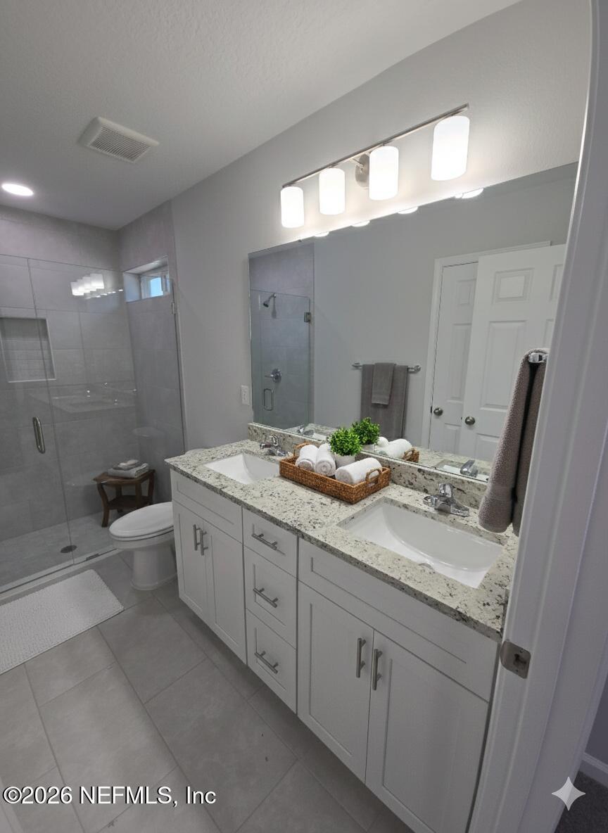 13611 Benton Street Jacksonville, FL 32218 - Photo 5 of 32 a bathroom with a double vanity sink and mirror with toilet