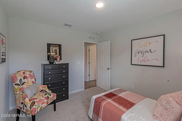 a bedroom with a bed and dresser