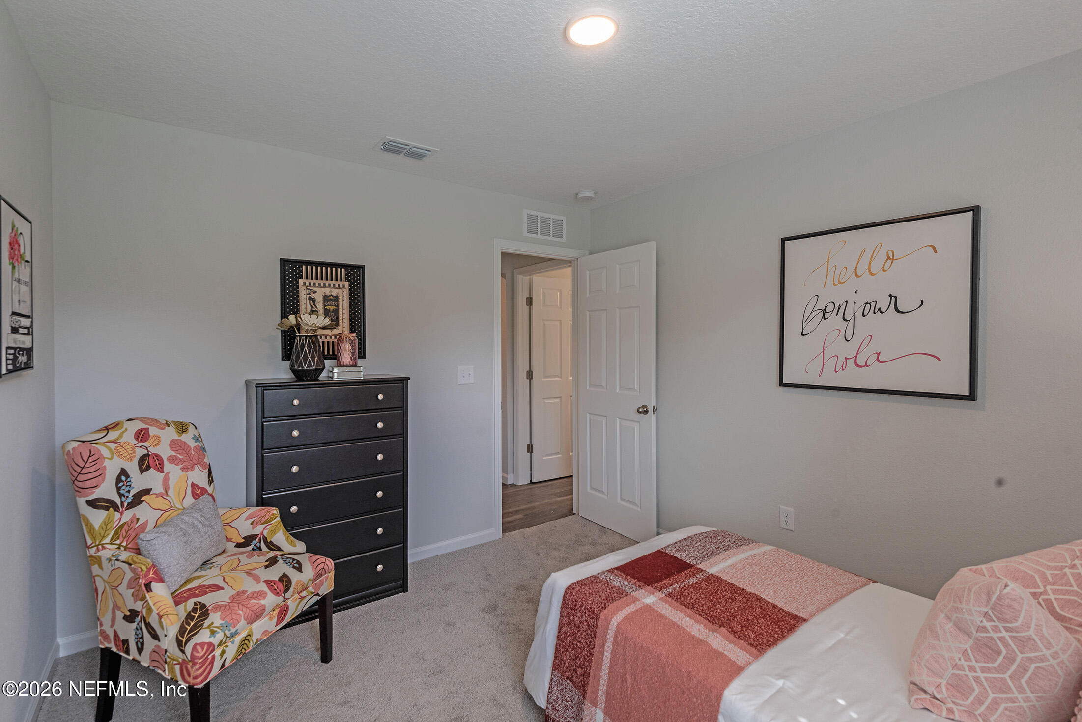 13611 Benton Street Jacksonville, FL 32218 - Photo 8 of 32 a bedroom with a bed and dresser