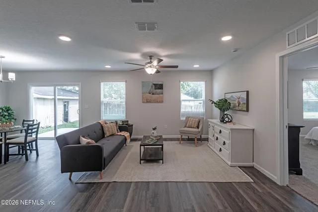 a living room with furniture and wooden floor
