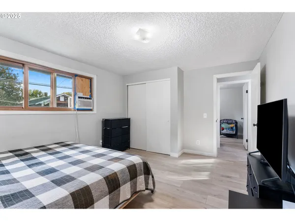 a bedroom with a bed and a flat screen tv