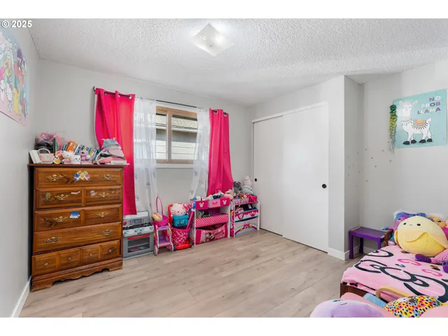 a bedroom with furniture and a window