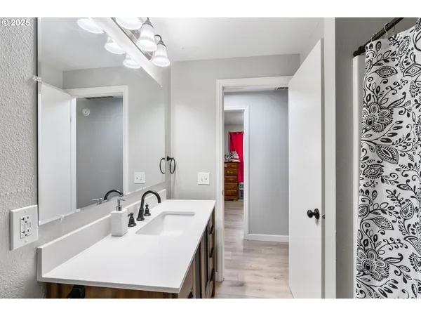 a bathroom with a sink vanity and a mirror