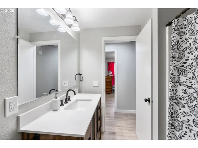a bathroom with a sink vanity and a mirror