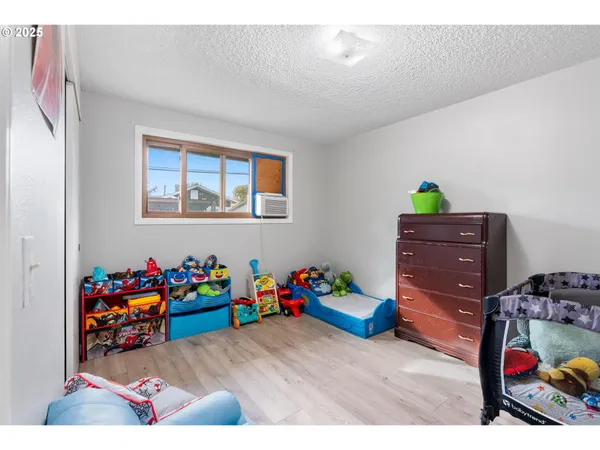a bed room with furniture and a baby crib