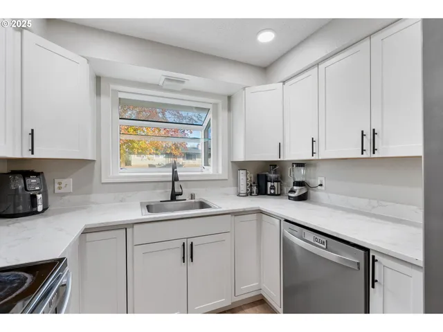 a kitchen with a sink cabinets and window