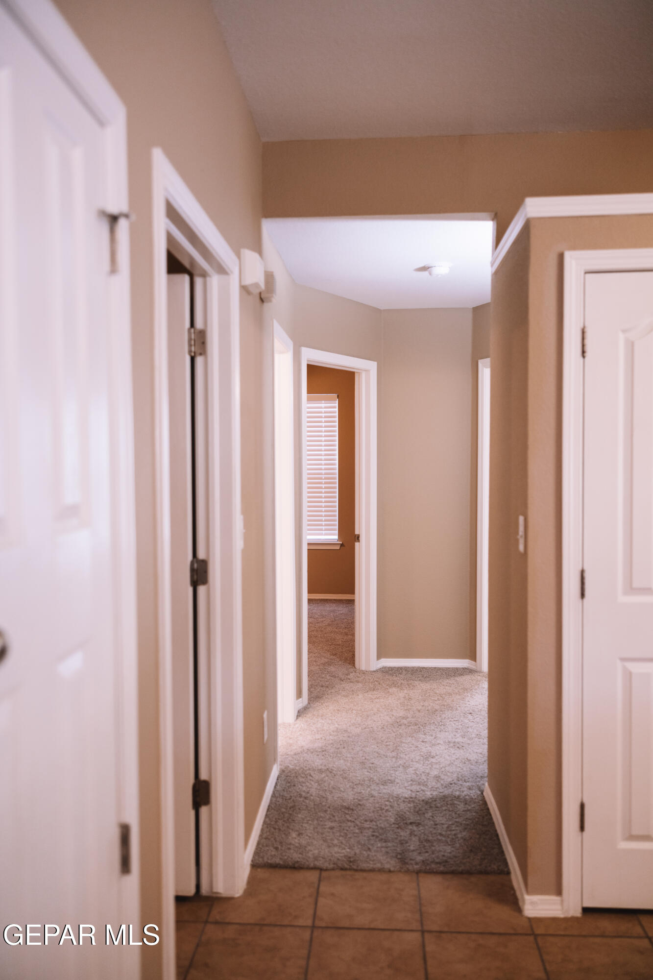 6824 Inca Dove El Paso, TX 79911 - Photo 6 of 18 a view of a hallway with wooden shelves