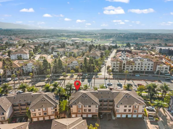 an aerial view of residential houses with outdoor space